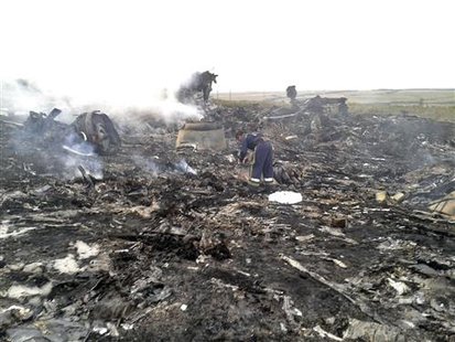 An Emergencies Ministry member at the site of a Malaysian Airlines passenger jet crash in Ukraine with 280 passengers and 15 crew members on board. (Credit: REUTERS/Maxim Zmeyev) An Emergencies Ministry member at the site of a Malaysian Airlines passenger jet crash in Ukraine with 280 passengers and 15 crew members on board. (Credit: REUTERS/Maxim Zmeyev)