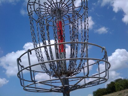A disc golf basket. A disc golf basket.