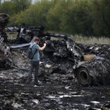 A journalist takes photographs at the site of Thursday's Malaysia Airlines Boeing 777 plane crash near the settlement of Grabovo, in the Donetsk region July 18, 2014.
REUTERS/Maxim Zmeyev A journalist takes photographs at the site of Thursday's Malaysia Airlines Boeing 777 plane crash near the settlement of Grabovo, in the Donetsk region July 18, 2014.
REUTERS/Maxim Zmeyev