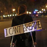  A protester wears a sign during a demonstration against the New York City grand jury decision to not indict in the death of Eric Garner, in Oakland, California December 3, 2014. CREDIT: REUTERS/STEPHEN LAM