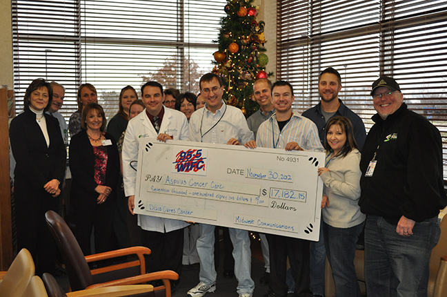 Aspirus and WIFC holding the proceeds check